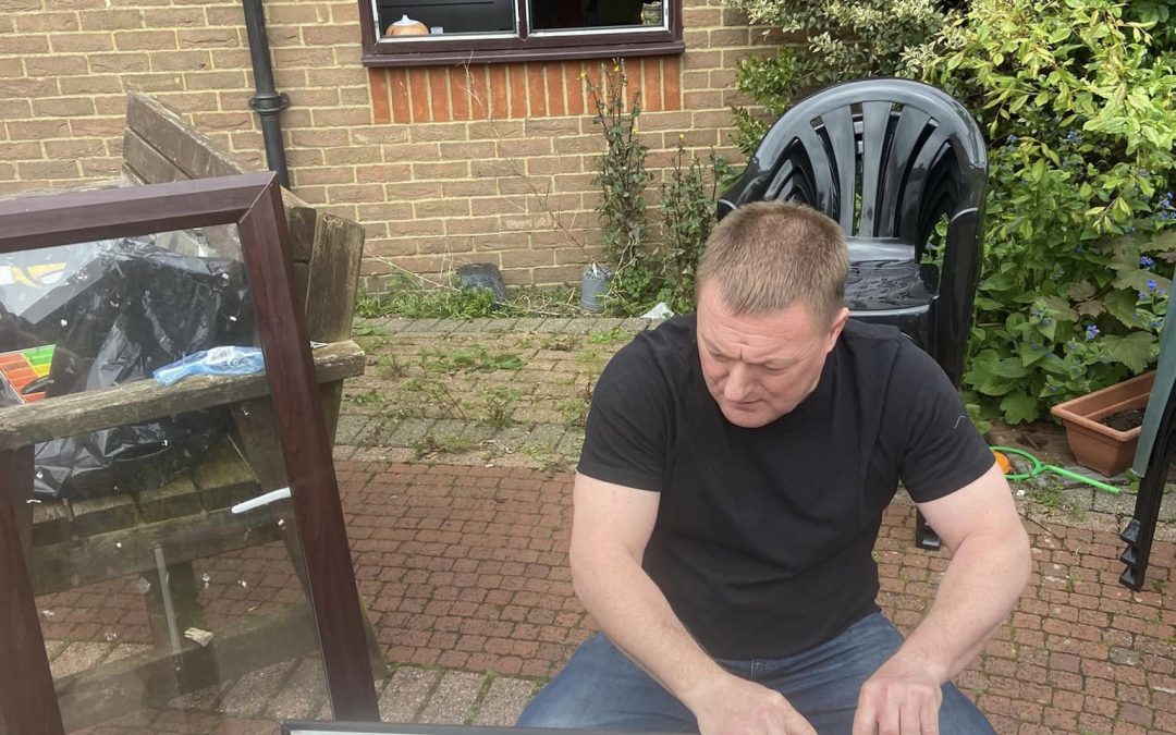 LBP locksmith holding the UPVC window