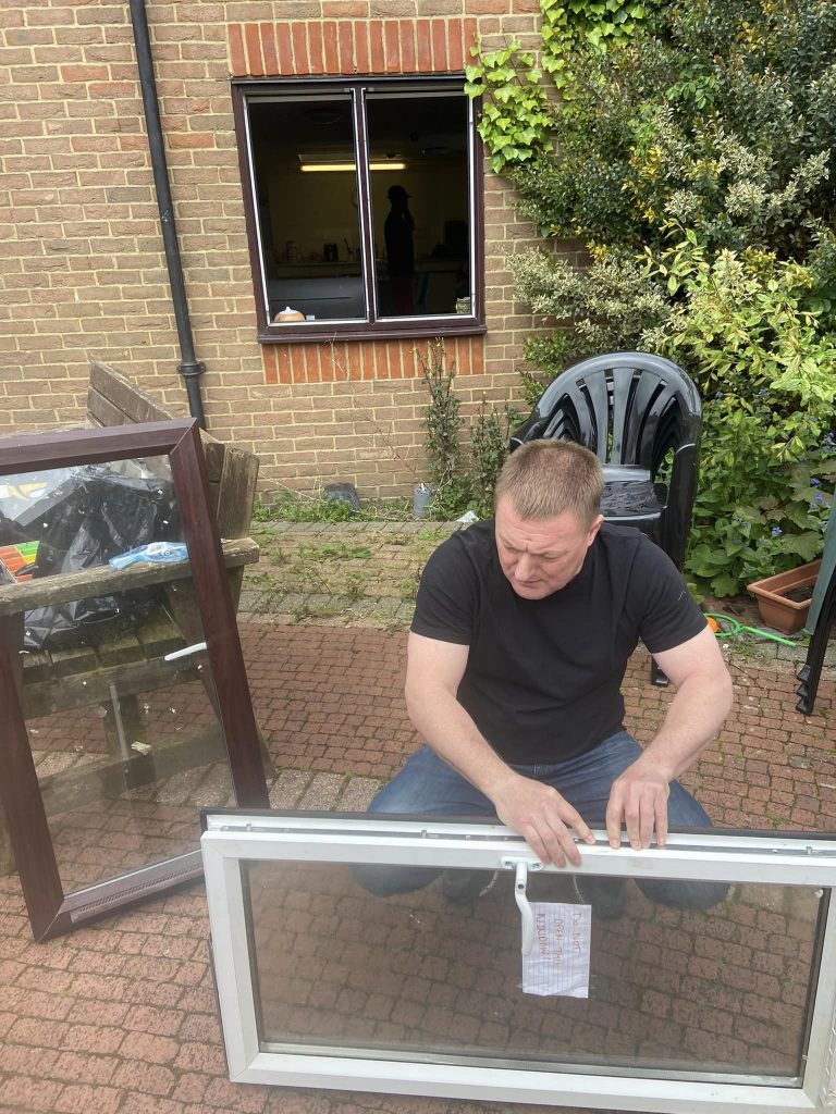 LBP locksmith holding the UPVC window
