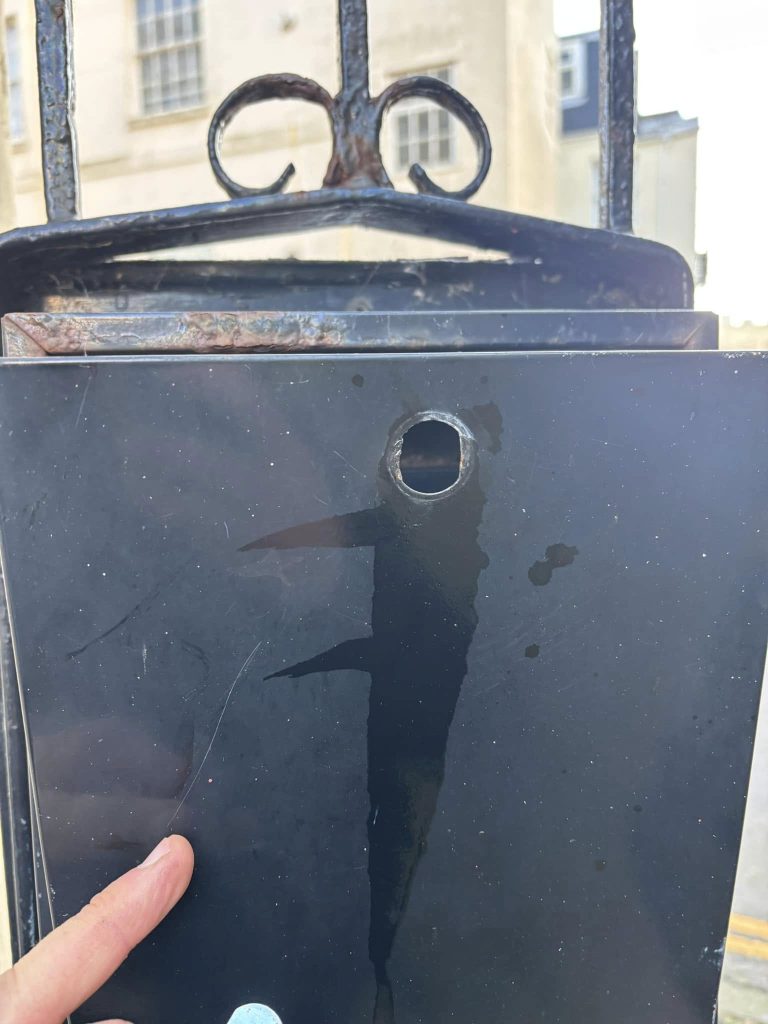 Letterbox with a hole from where a cam lock is removed
