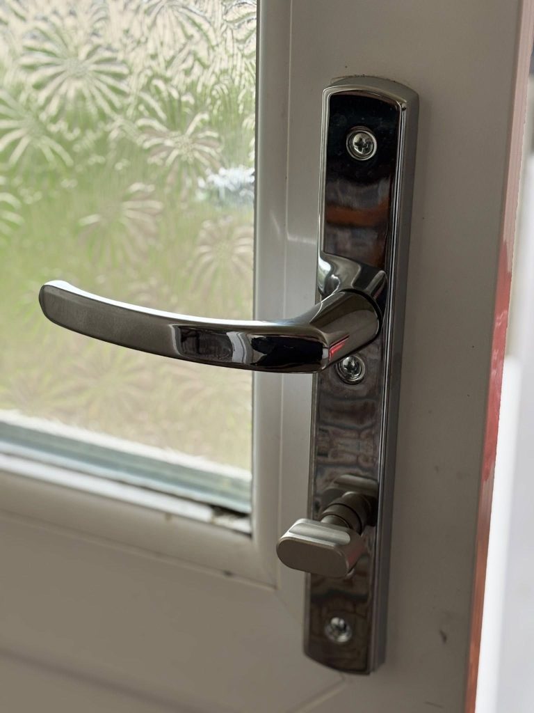 A close-up of a multipoint locking unit installed on a door