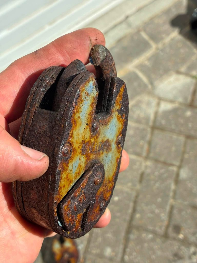 Rusty old Bulldog lock removed safely from stable doors
